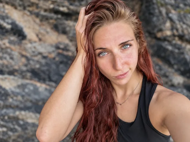 Portrait of Aida Marin beside a rock face
